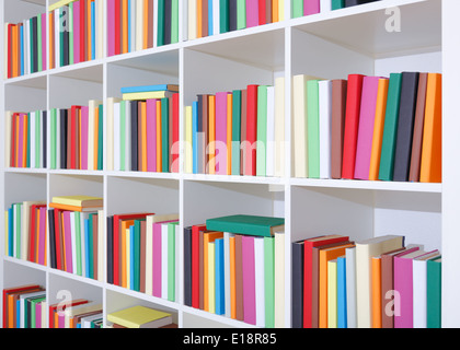 Libri su un ripiano bianco, una pila di libri colorati in libreria Foto Stock