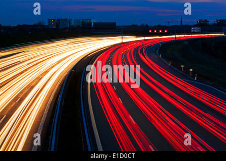 Auto di notte su una autostrada. Luci di corda e insegne luminose Foto Stock