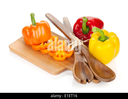 Colorato i peperoni e utensili da cucina. Isolato su sfondo bianco Foto Stock