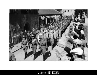 ANSCHLUSS AUSTRIA Mar 12, 1938 Hitler annuncia l'annessione di Anschluss all'Austria le truppe naziste Wehrmacht marciano con bandiere swastika per salutare la folla Foto Stock