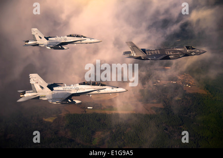 Un U.S. Marine Corps (USMC) F-35 Lightening II aeromobili è scortato da due USMC F-18 calabroni come vola verso Eglin Air Force Foto Stock