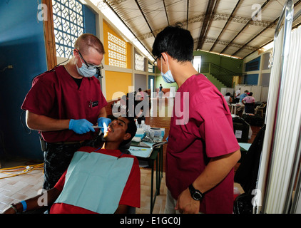 Stati Uniti Navy Lt. Joshua Fair, sinistra, un dentista da nave ospedale USNS Comfort (T-AH 20) e di una organizzazione non governativa vo Foto Stock