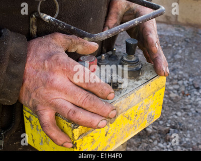 Edificio autonomo house, versando soletta, mani di uomo concreto funzionamento pompa di comando remoto Foto Stock