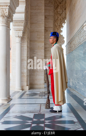 Una guardia reale sta accanto a una porta del Mausoleo di Mohammed V nella città di Rabat in Marocco. Foto Stock