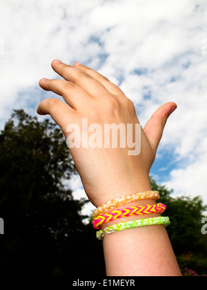 Rainbow telaio braccialetto bande sulla ragazza del polso Foto Stock