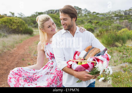 Carino coppia andando per un picnic a sorridere a ogni altro Foto Stock