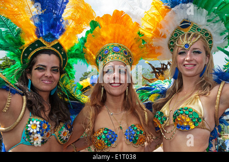 Tre donne vestite nel tradizionale brasiliano Mardi Gras costumi, prendendo parte a Glasgow, in zona west end festival. Foto Stock