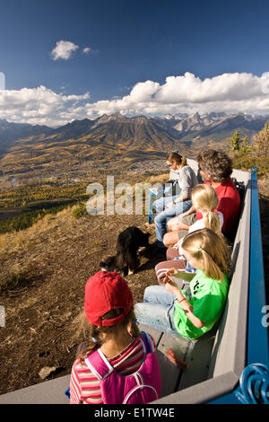 Famiglia giovane rilassa su banco, Castle Mountain Trail, Fernie, BC, Canada Foto Stock