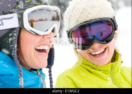 Due giovani donne ridere mentre su una vacanza sciistica nelle montagne Monashee, British Columbia Foto Stock