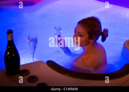 Donne attraenti rilassante nel caldo del tubo e bere champagne Vigilia di Capodanno Foto Stock