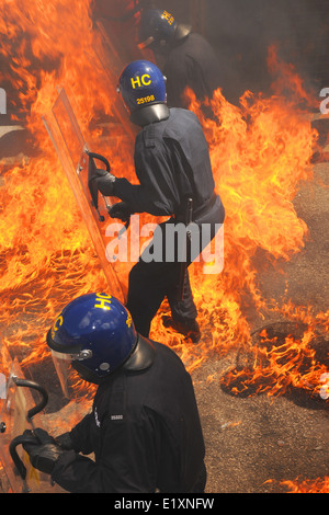 Estremamente realistica la formazione della polizia per motivi di ordine pubblico e di disturbo l'uso di bombe a benzina. Hampshire, Inghilterra, Giugno 2014. Foto Stock