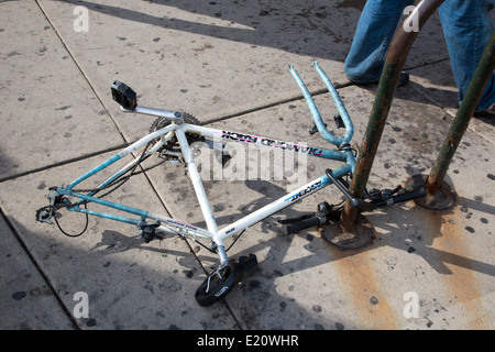 Denver, Colorado - il telaio di una bicicletta, bloccato ad un supporto bici con le ruote rimossi. Foto Stock