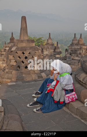 Ragazze musulmane di visitare gli antichi Borobudur tempio Buddista vicino a Yogyakarta, Indonesia Foto Stock