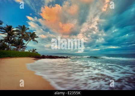 Sunrise le onde del mare e palme sulla spiaggia. Maui, Hawaii Foto Stock