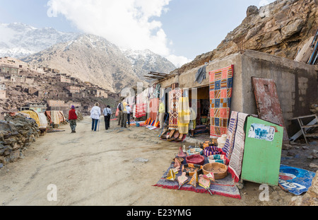 I negozi sulla via di una vendita di coperte e altri souvenir in Alto Atlante, Marocco al passaggio di escursionisti e appassionati di trekking Foto Stock