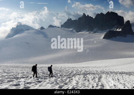 Due alpinisti sul ghiacciaio del Trient nelle Alpi francesi con le Aiguilles Dorées oltre Foto Stock