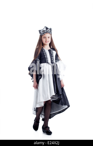 Ragazza carina in posa di arlecchino vestito con maschera Foto Stock