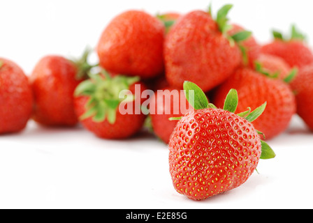 Molti frutti di fragole isolato su bianco - alcune sono fuori di DOF Foto Stock
