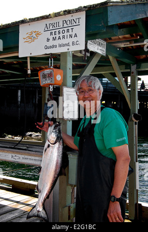 Asian pescatore di pesatura Salmone Chinook aprile punto Lodge Quadra Island BC Foto Stock