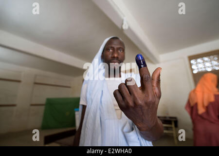 Nouakchott, Mauritania. Il 21 giugno, 2014. Un uomo mostra il suo dito inchiostrato come egli esce dalla stazione di polling.Mauritanians sono accorsi alla stazione di polling nel tentativo di eleggere il presidente.attuale presidente Abdel Aziz, che ha posizionato a se stesso come un occidentale alleato nella lotta contro i militanti islamici, led 2008 un colpo di stato militare che aveva esautorato Mauritania il primo presidente eletto. Credito: ZUMA Press, Inc./Alamy Live News Foto Stock