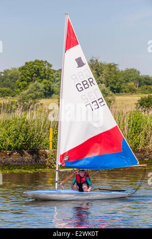 Norfolk, Regno Unito. Il 21 giugno, 2014. Charlie Oram età 10 dell'Beccles Amateur Sailing Club gode di una perfetta giornata d'estate la vela un Topper sul fiume Waveney su Norfolk Broads in Norfolk, Inghilterra, UK Credit: T.M.O.News/Alamy Live News Foto Stock