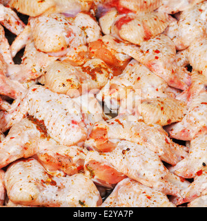 Materie marinato ali di pollo sulla piastra close up Foto Stock