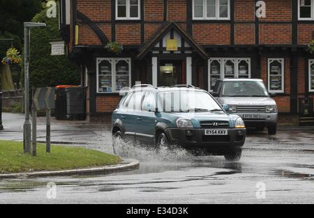 Wet Weather immagini formano Beaconsfield, Bucks. Persone sedersi sulle panche sotto gli ombrelloni, una sposa determinato ad avere una buona giornata, cattive condizioni stradali dotate di: automobili guida sotto la pioggia dove: Beaconsfield, Buckinghamshire, Regno Unito quando: 15 Giu 2013 Foto Stock