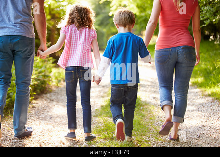 Vista posteriore della famiglia passeggiate in campagna Foto Stock