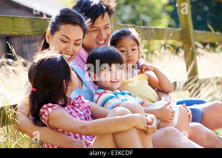 Famiglia asiatica rilassante dal cancello sulla passeggiata in campagna Foto Stock