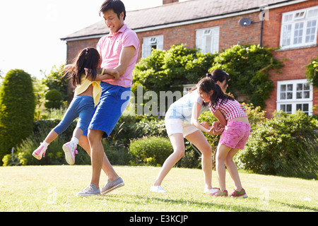 Famiglia asiatica giocando nel giardino estivo insieme Foto Stock