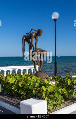 Sculture decorative lungo il Malecon con navi da crociera nel porto di Cozumel, Messico. Foto Stock