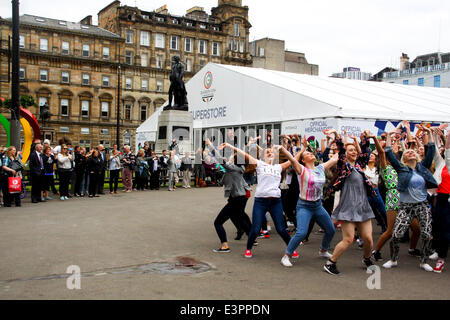 Glasgow, Scotland, Regno Unito. Il 27 giugno, 2014. Un flashmob di 100 ballerini araldi l'apertura dei giochi ufficiali merchandise superstore dal Chief Executive David Grevemberg Credito: ALAN OLIVER/Alamy Live News Foto Stock