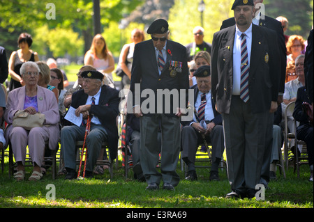 I politici e i membri del pubblico, veterani e servendo il personale militare assistere ad una cerimonia in occasione del settantesimo anniversario del D-day. Foto Stock