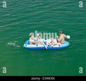 Tre uomini in una barca gonfiabile. Foto Stock