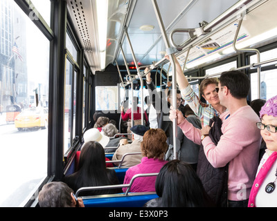 Passeggeri in sella all'interno del bus pubblico, NYC, STATI UNITI D'AMERICA Foto Stock