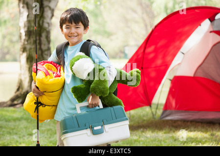 Ragazzo asiatico che trasportano attrezzatura da campeggio Foto Stock