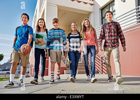 Gli adolescenti a piedi fuori della scuola Foto Stock