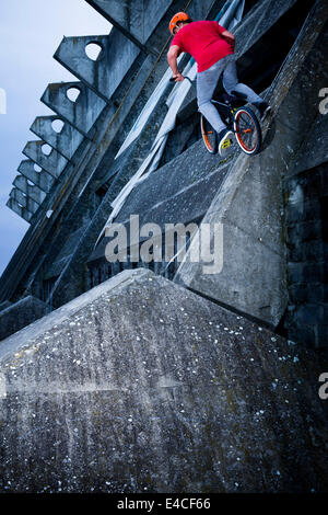 BMX biker eseguendo uno stunt su un ponte Foto Stock