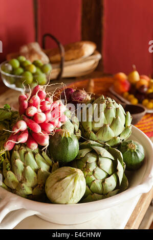 Carciofi e ravanelli in una ciotola Foto Stock