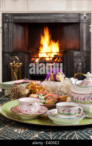 19C dipinte a mano porcellana lustre set da tè il vassoio con i biscotti di Natale di fronte al caminetto Foto Stock