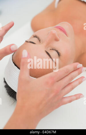 Tranquillo brunette ricevendo la terapia reiki Foto Stock