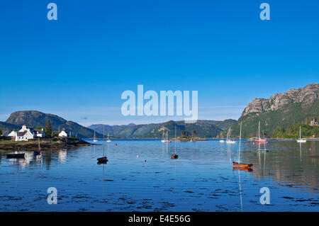 Piccole barche ancorate in Plockton Harbour, Loch Carron, tranquilla serata estiva, riflessioni, Wester Ross Highlands, Scotland Regno Unito Foto Stock