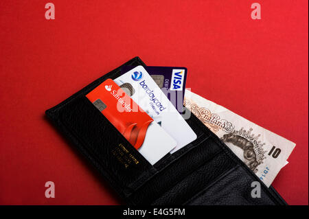 Portafoglio con carte di credito e di debito e sterling banconote. Foto Stock