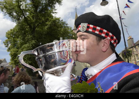 Jedburgh, Scottish Borders, UK. 7 Luglio, 2014. Jethart Callant del Festival 2014 Jethart Jack Callant Fraser sorride con orgoglio alla chiusura della mattina i cerimoniali, raffigurato con la Jethart Callants Cup sul giorno del Festival. La Scottish comune festival di equitazione sono eventi annuali in cui i locali cavalcare su cavalli a ceremonially controllare e proteggere le terre comuni della loro città. Credito: Rob grigio/Alamy Live News Foto Stock