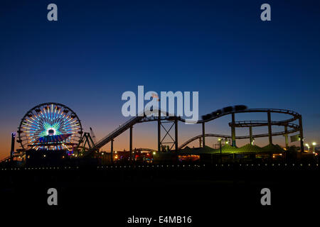 Ruota panoramica Ferris e il roller coaster al crepuscolo, Pacific Park, Santa Monica Pier, Santa Monica, Los Angeles, California, Stati Uniti d'America Foto Stock