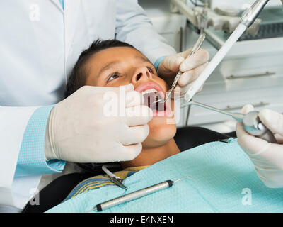 Ragazzo (10-11) essendo trattate in studio dentistico Foto Stock