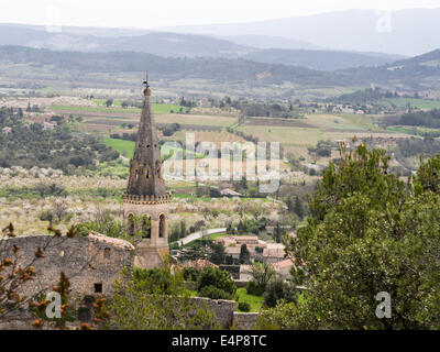 Campanile in St-Saturnin-les -Apt. Torre del borgo inferiore la chiesa con le aziende agricole della valle, frutteti e vigneti al di sotto di Foto Stock