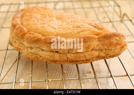 Fresco cotto al forno tradizionale Cornish pasty raffreddamento su un rack Foto Stock