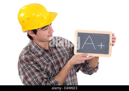 Giovane apprendista azienda ardesia Foto Stock