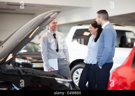 Venditore di sorridere quando parla di un giovane Foto Stock